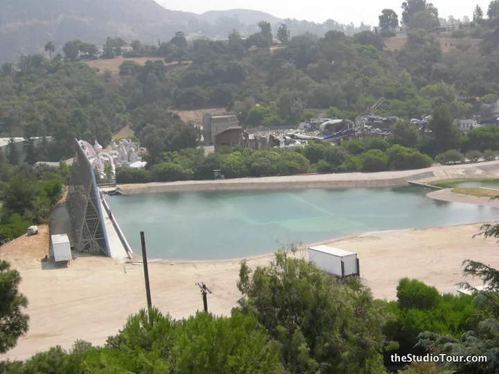 Falls Lake outdoor water tank at Universal Studios Hollywood with the scenic backdrop and studio lot around it.