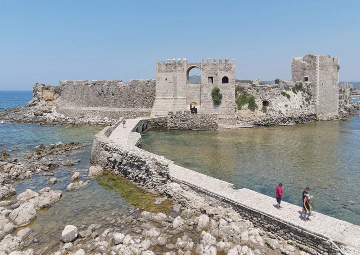 Sea-facing stone walls and Bourtzi of Methoni Castle in Greece.